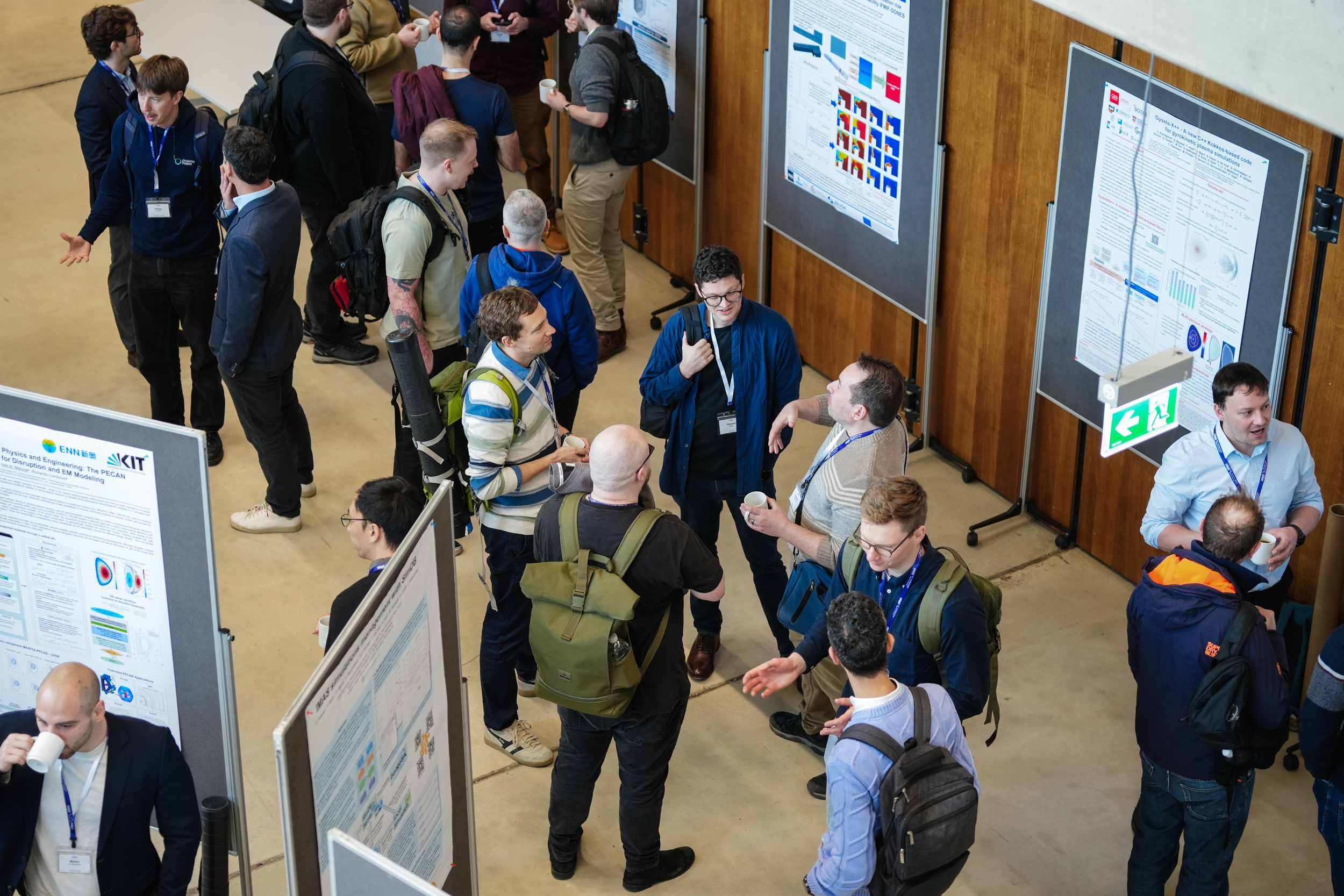 Researchers discussing posters during a break at OSSFE 2026